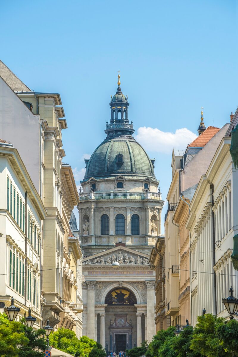 Architectural photograph of a domed basilica framed by city buildings